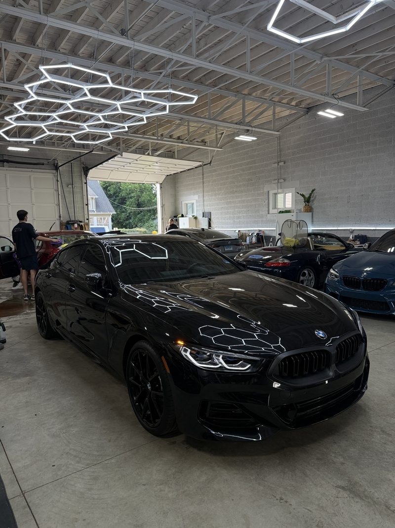 Black BMW 840 under the studio lighting at DetailHaus