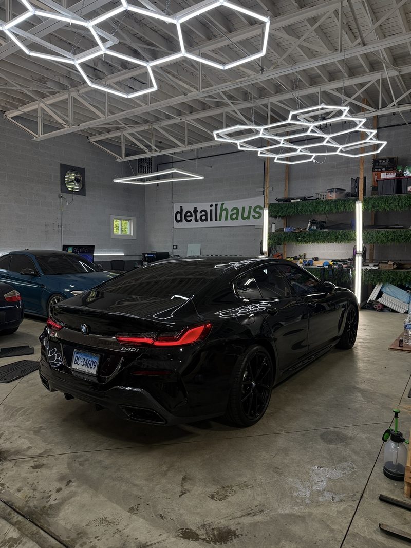 Rear quarter of a black BMW 840i at DetailHaus